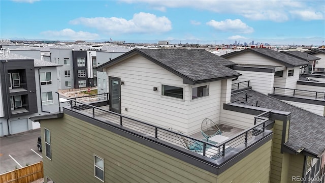 8742 E 47th Ave, Denver, CO 80238 - rear view of house featuring a balcony and roof with shingles