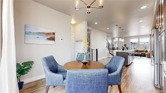 8742 E 47th Ave, Denver, CO 80238 - dining area with a chandelier, light wood-type flooring, baseboards, and recessed lighting