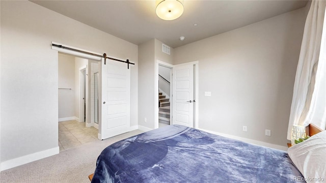 8742 E 47th Ave, Denver, CO 80238 - bedroom with carpet floors, a barn door, and baseboards