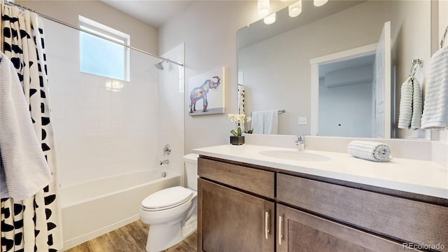 8742 E 47th Ave, Denver, CO 80238 - bathroom featuring wood finished floors, toilet, vanity, and shower / tub combo with curtain