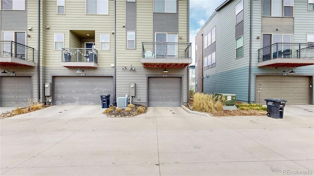 8742 E 47th Ave, Denver, CO 80238 - rear view of property featuring an attached garage and driveway