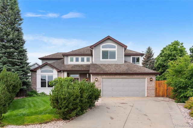6643 Orion Ct, Arvada, CO 80007 - view of front of home featuring concrete driveway, brick siding, a shingled roof, and a garage