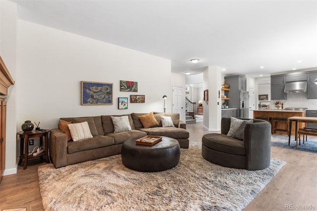 6643 Orion Ct, Arvada, CO 80007 - living area featuring light wood-style floors, stairs, and recessed lighting