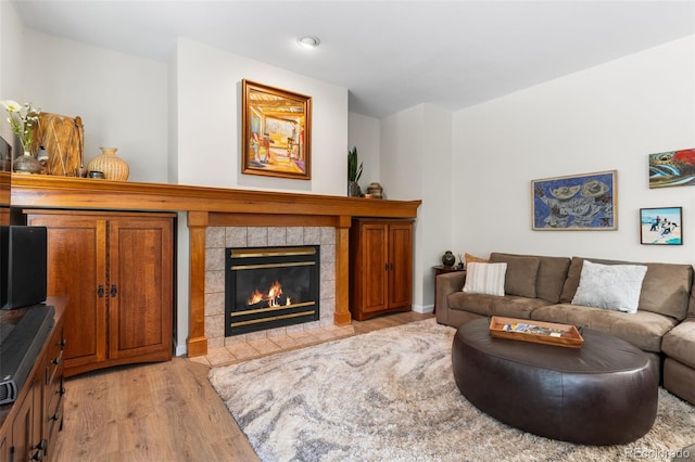 6643 Orion Ct, Arvada, CO 80007 - living room with light wood finished floors, a tile fireplace, and recessed lighting