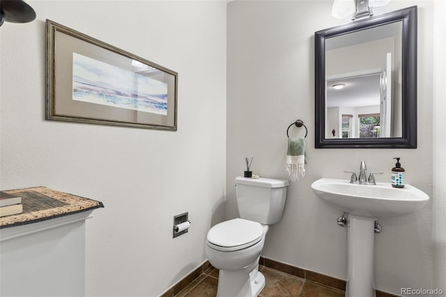 6643 Orion Ct, Arvada, CO 80007 - half bath featuring toilet and tile patterned floors