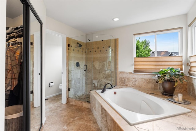 6643 Orion Ct, Arvada, CO 80007 - bathroom with a bath, a shower stall, a walk in closet, and recessed lighting