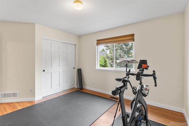 6643 Orion Ct, Arvada, CO 80007 - exercise room featuring wood finished floors and baseboards