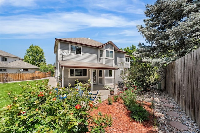 6643 Orion Ct, Arvada, CO 80007 - back of house featuring a fenced backyard and a patio area