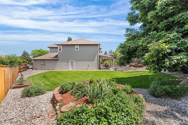 6643 Orion Ct, Arvada, CO 80007 - back of house with a fenced backyard and roof with shingles