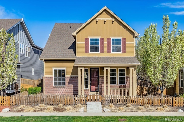 11896 Meade Ct, Westminster, CO 80031 - view of front of property featuring covered porch, brick siding, board and batten siding, and a fenced front yard