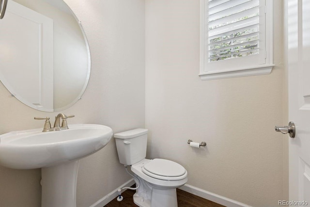 11896 Meade Ct, Westminster, CO 80031 - half bathroom featuring baseboards and wood finished floors