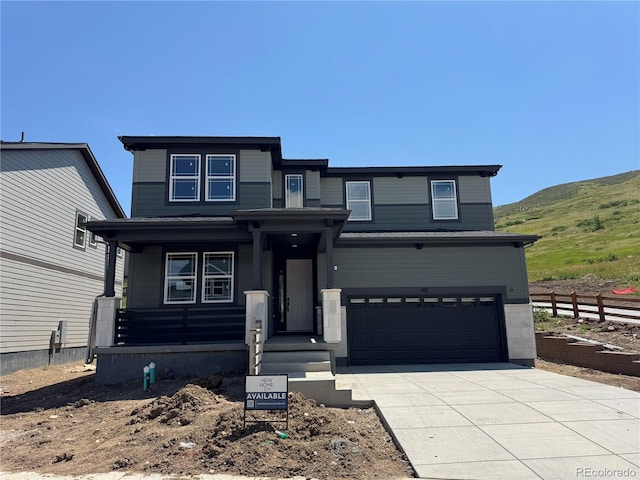 143 S Seacrest St, Golden, CO 80401 - view of front of home featuring driveway, a garage, a mountain view, and a porch