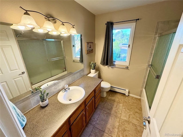 4949 W 13th St, Greeley, CO 80634 - full bath featuring a baseboard radiator, plenty of natural light, vanity, and toilet