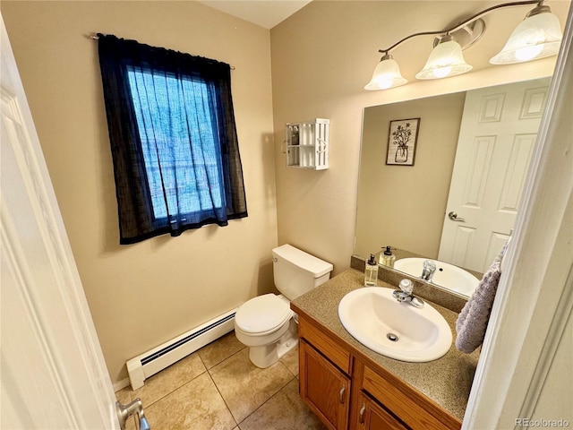 4949 W 13th St, Greeley, CO 80634 - bathroom with baseboard heating, vanity, toilet, tile patterned floors, and baseboards