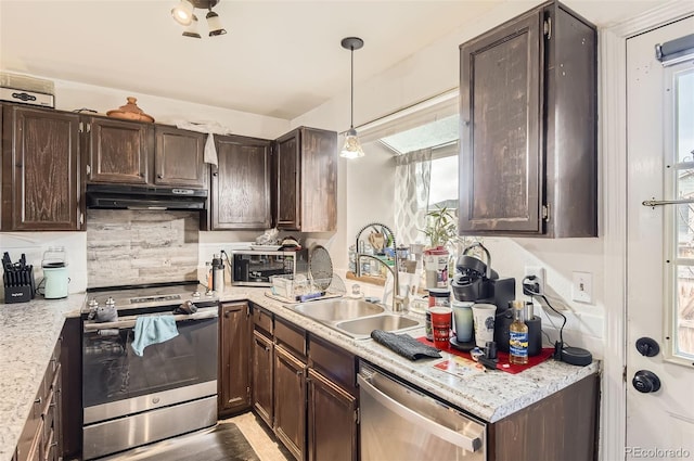 kitchen featuring under cabinet range hood, dark brown cabinetry, appliances with stainless steel finishes, and a sink
