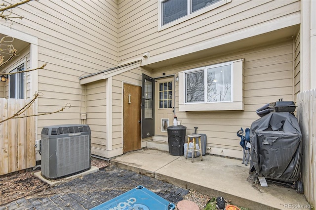 exterior space with grilling area, fence, and central AC unit