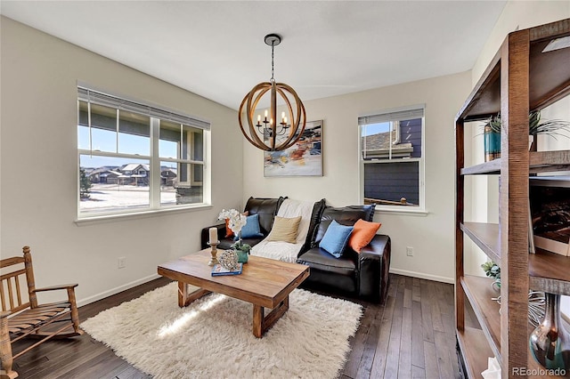 living room with a chandelier and dark hardwood / wood-style floors