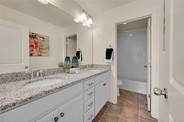 full bathroom featuring tiled shower / bath combo, vanity, toilet, and tile patterned floors