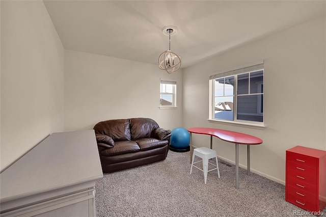 living room featuring an inviting chandelier and carpet floors