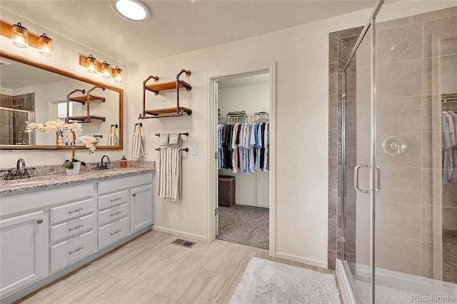 bathroom featuring vanity and an enclosed shower