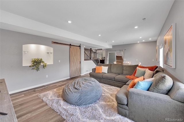 living room featuring hardwood / wood-style floors and a barn door