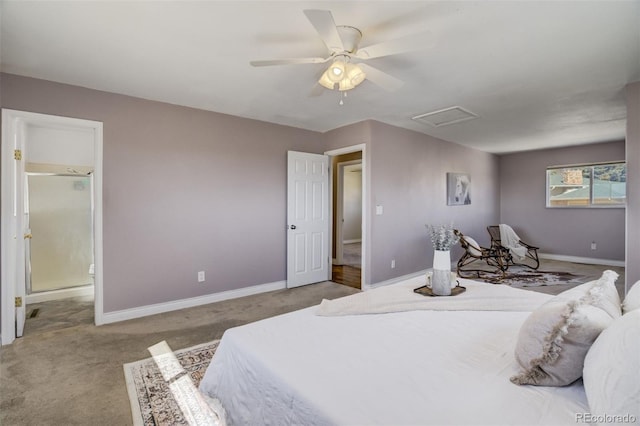 carpeted bedroom with ensuite bath, attic access, baseboards, and ceiling fan