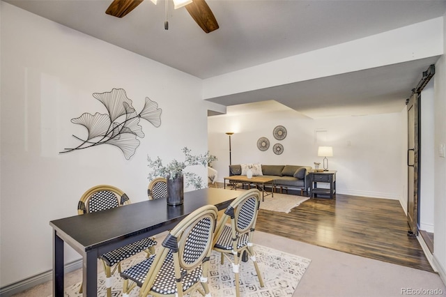 office area with baseboards, wood finished floors, and a ceiling fan