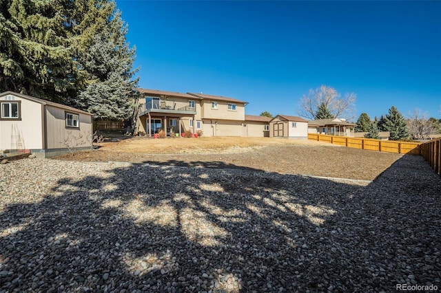 view of yard with a fenced backyard, a storage shed, and an outdoor structure