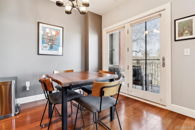 dining room with a chandelier and dark wood-type flooring