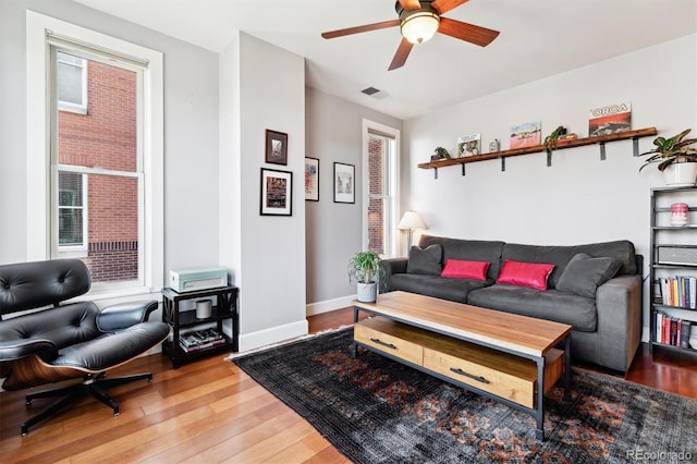 living room with hardwood / wood-style flooring, ceiling fan, and a healthy amount of sunlight