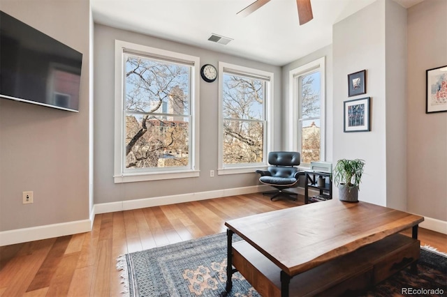 sitting room with ceiling fan and hardwood / wood-style floors