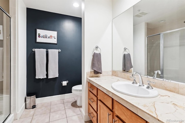 bathroom with toilet, a shower with door, tile patterned flooring, and vanity