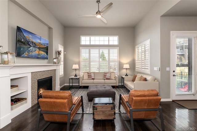 living room with dark wood-type flooring and ceiling fan