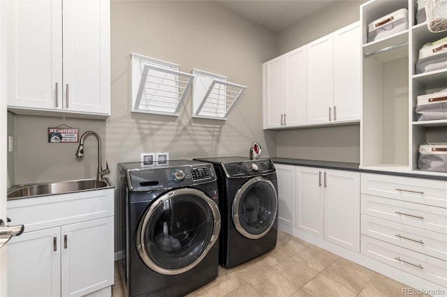 clothes washing area with cabinets, separate washer and dryer, sink, and light tile patterned floors