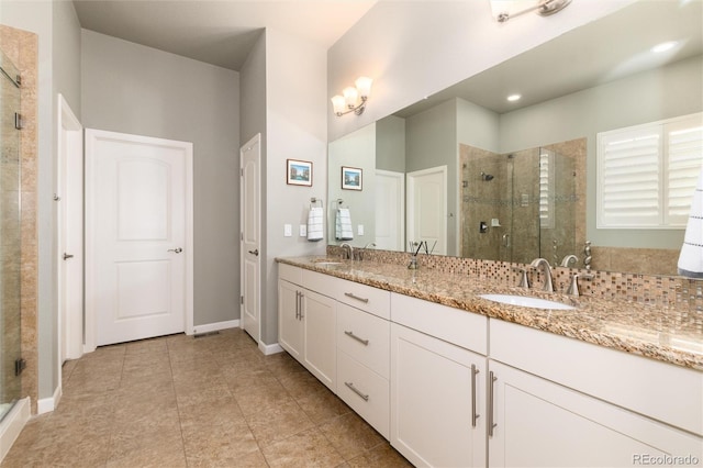 bathroom featuring vanity, an enclosed shower, and tile patterned floors