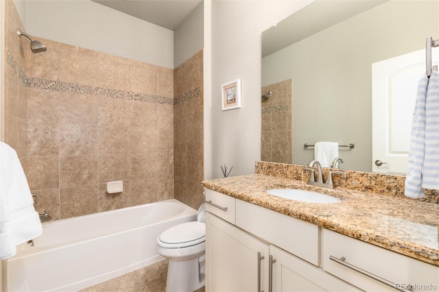 full bathroom featuring tiled shower / bath, vanity, tile patterned floors, and toilet