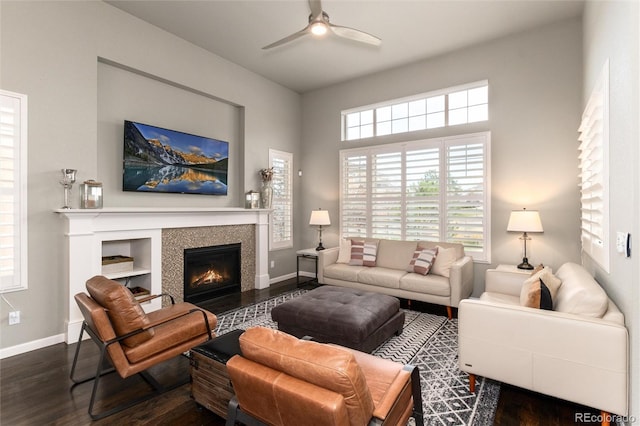 living room with ceiling fan and dark hardwood / wood-style flooring