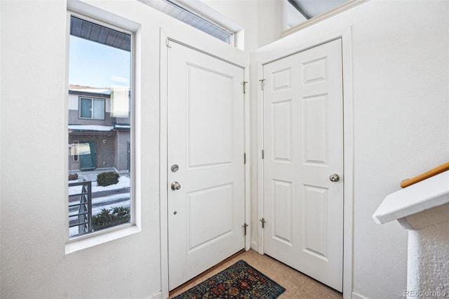 foyer entrance with light tile patterned flooring
