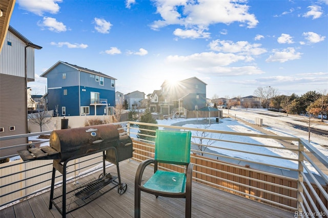 wooden deck featuring a grill and a residential view