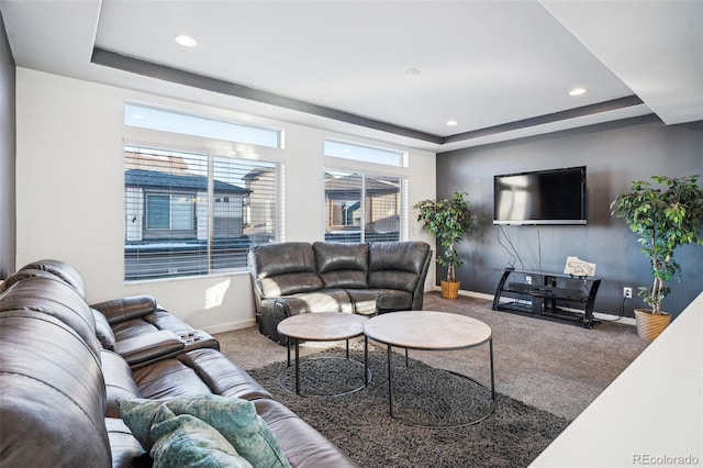 carpeted living room featuring baseboards, a tray ceiling, and recessed lighting