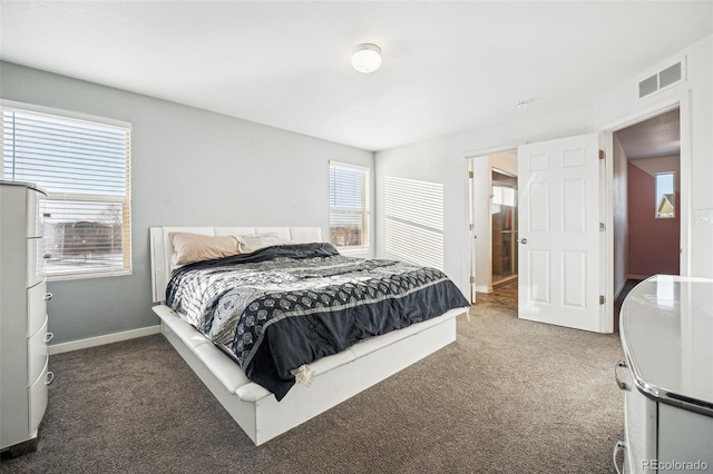 bedroom with baseboards, visible vents, and dark carpet