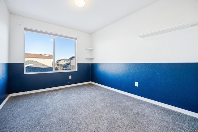 empty room featuring baseboards and carpet flooring