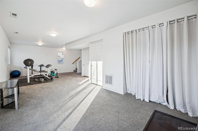 exercise area featuring carpet, visible vents, and baseboards