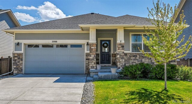 3086 Kestrel St, Brighton, CO 80601 - view of front of home with driveway, stone siding, a front lawn, an attached garage, and a shingled roof