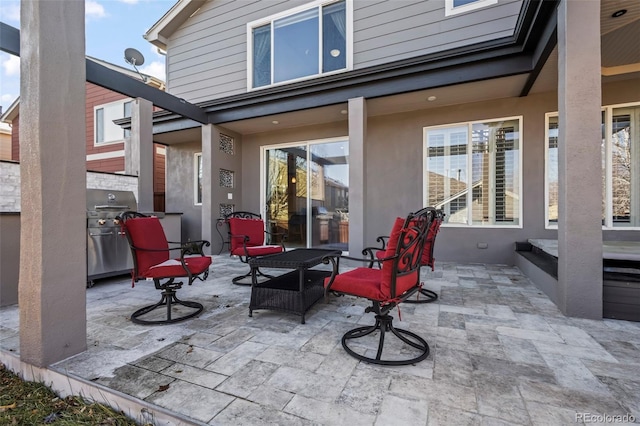 view of patio featuring exterior kitchen and a grill