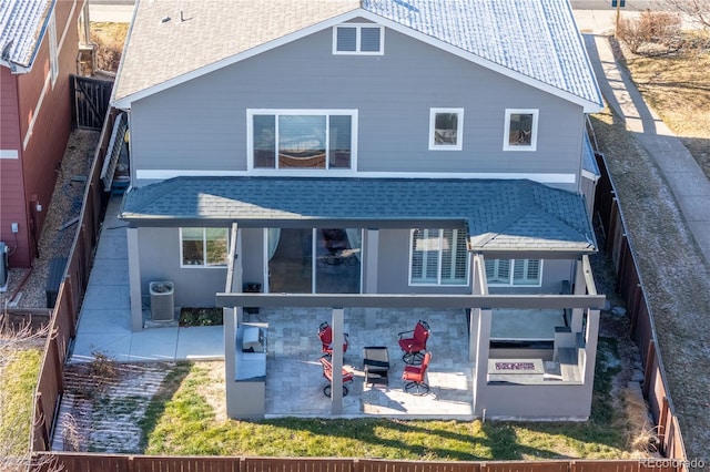 back of property with cooling unit and a patio area