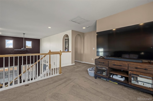 carpeted living room with ceiling fan