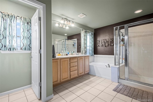 bathroom with tile patterned floors, vanity, and plus walk in shower