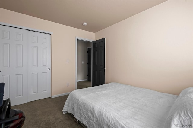 bedroom with dark colored carpet and a closet