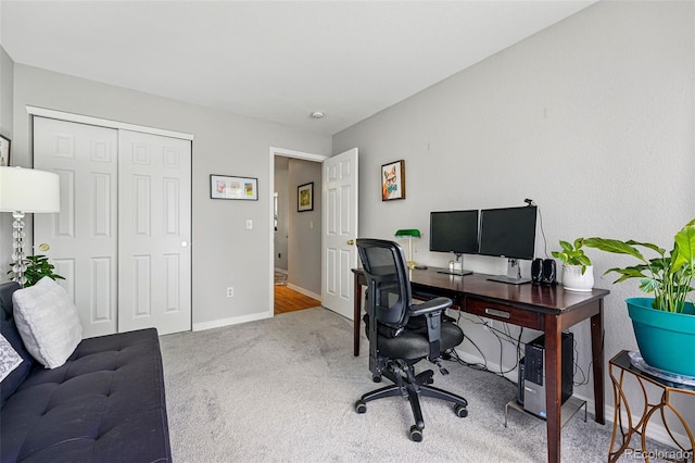 carpeted office featuring baseboards